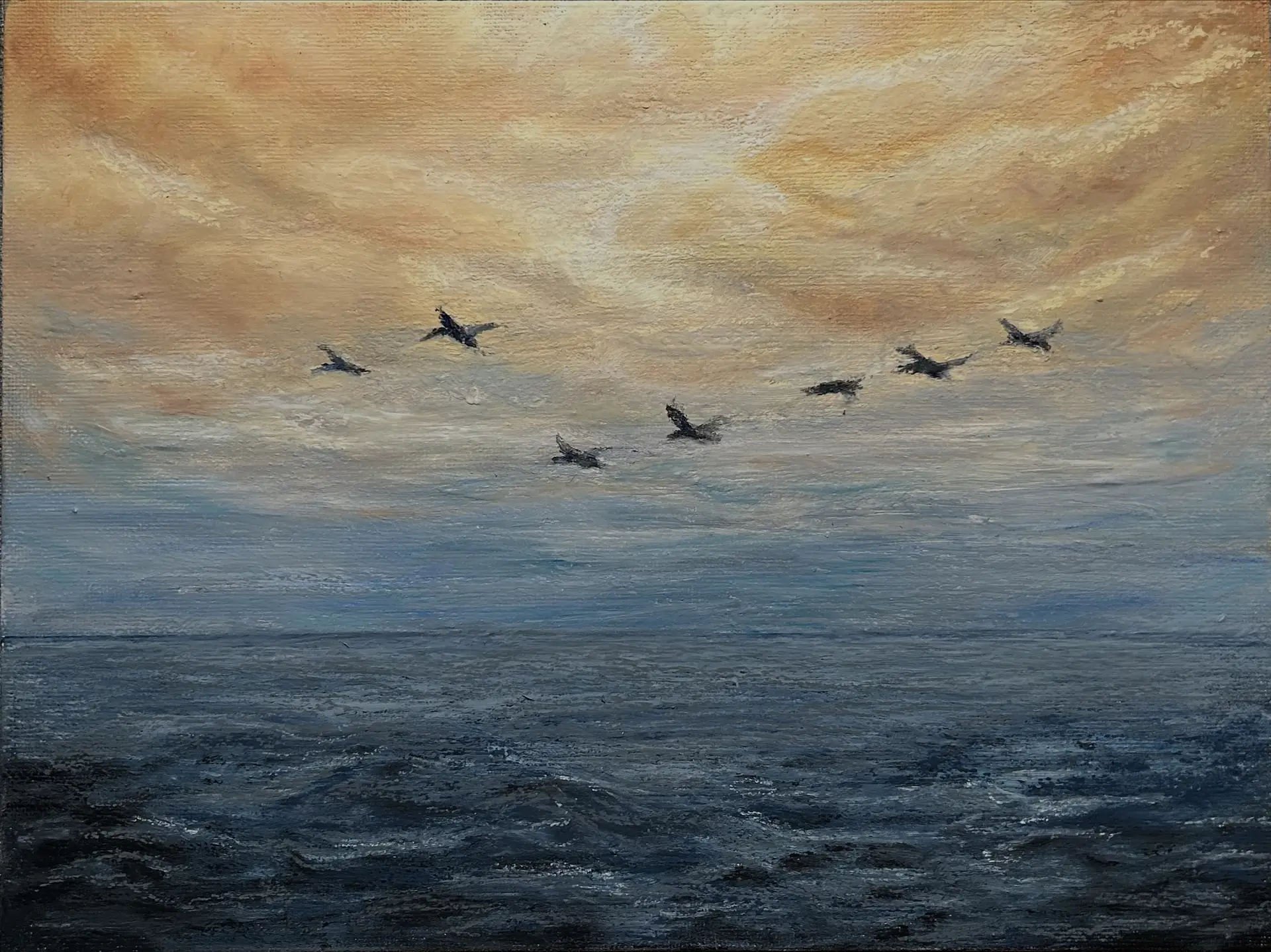 photo of a painting by Katie. It's made with oil pastels and shows a stormy sea with yellow cloudy sky and several birds flying by in the distance.